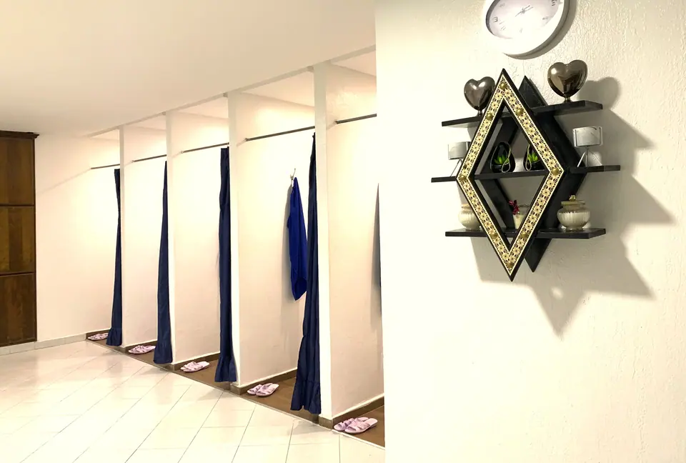 Changing cubicles with navy curtains